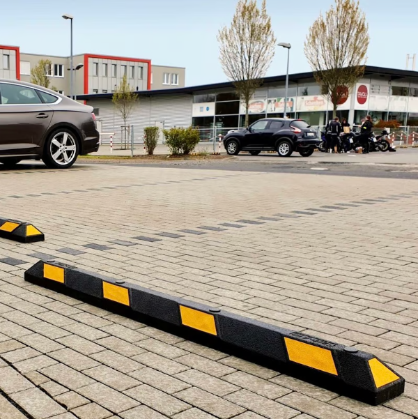 TRAFFIC-LINE Park-AID yellow/black wheel stop in situ in a car park